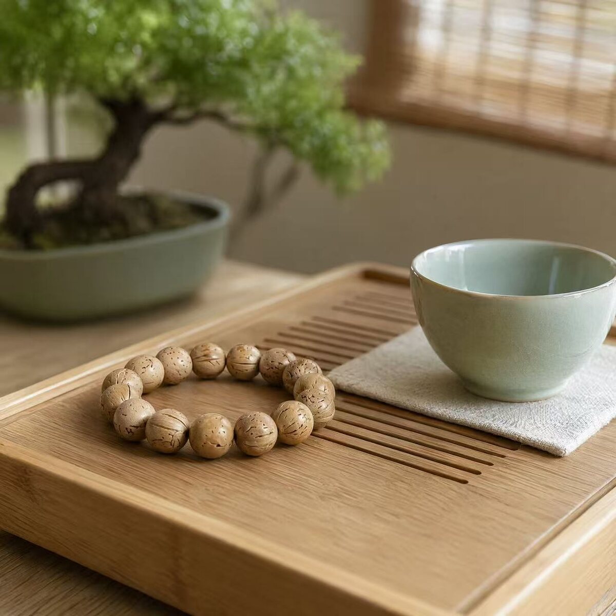 Spotted natural-tone beaded bracelet on a tea tray