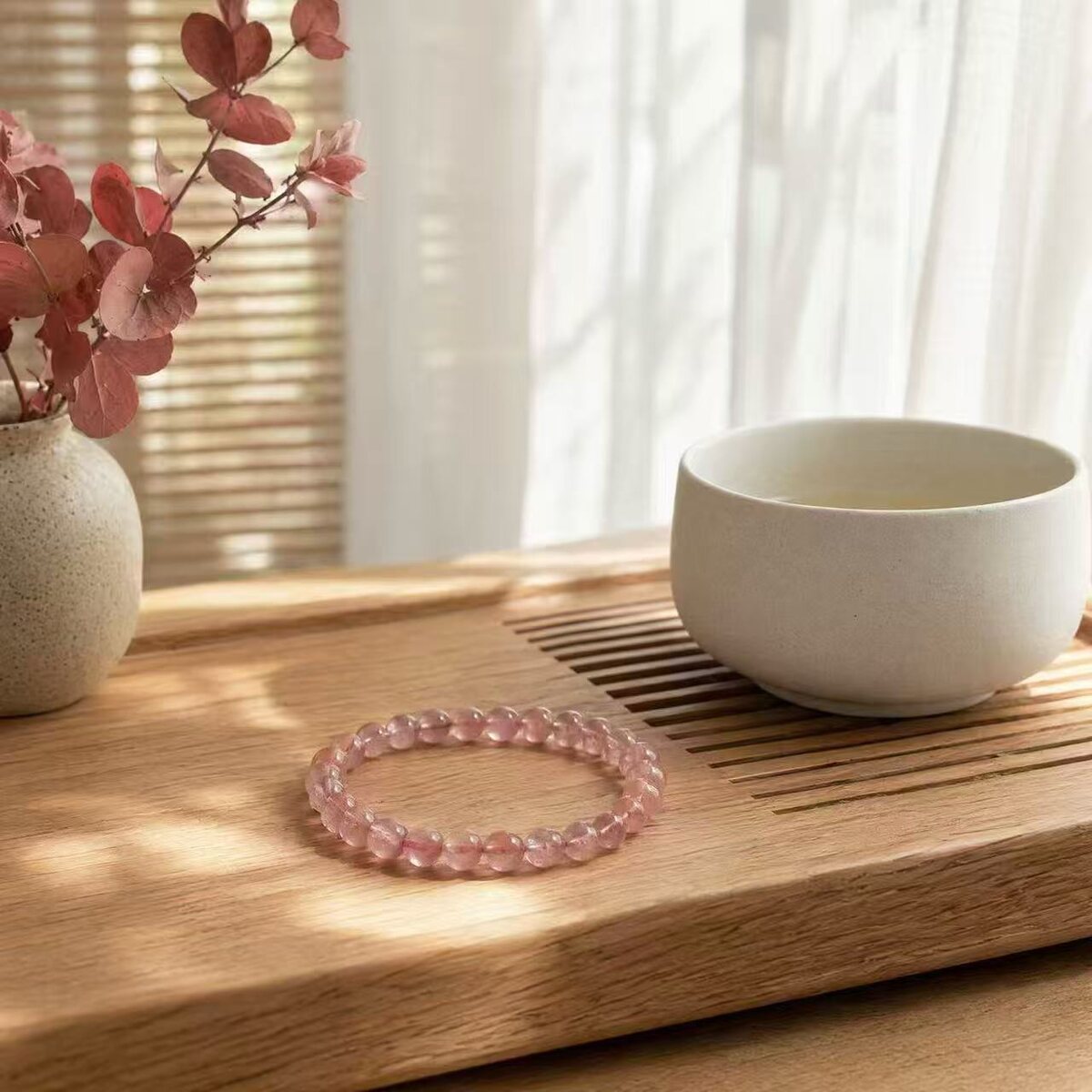 Transparent pink beaded bracelet on a table